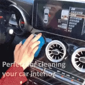 Blue CleanGel pressed into a car air vent, the dust stays stuck in the gel