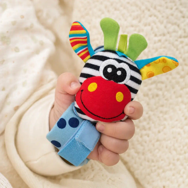 Baby hand gripping the RattlePals wrist rattle
