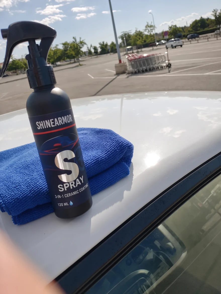 Customer photo: ShineArmor bottle on the roof of a white car in a parking lot