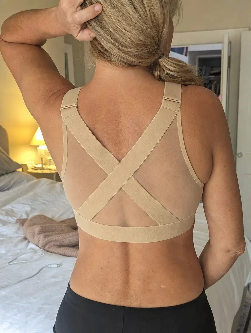 Customer photo: beige PostureBra worn in a bedroom, straps crossed at the back